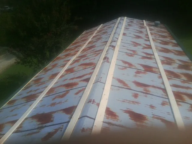 Rusted metal roof panels with new wood purlins before replacement — Storm Damage Roof Repair in Blountville by Roofing Brothers