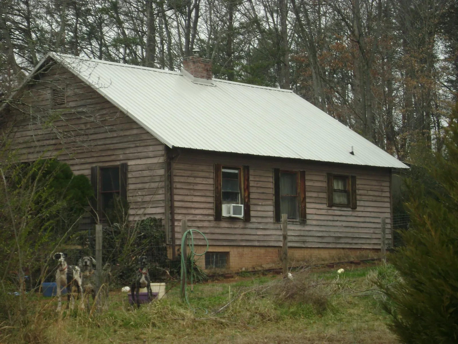 White metal roof on an old wood sided farmhouse, from a Metal Roof Installation job in Blountville